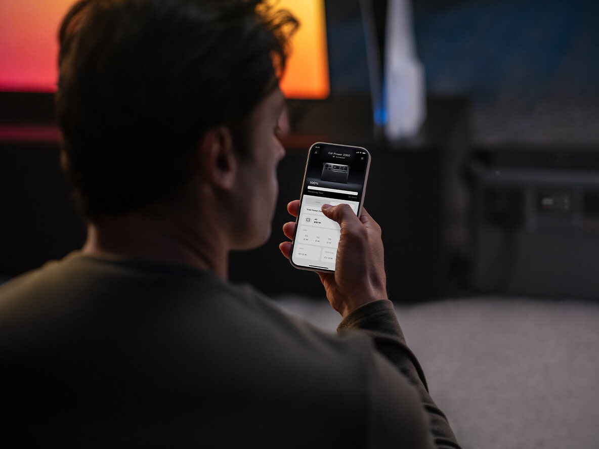 Person controlling a DJI Power 2000 with the DJI Home app on a handheld phone